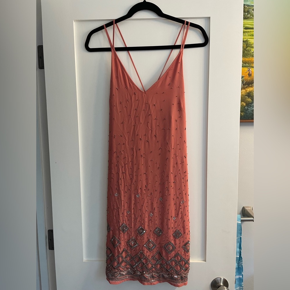 Size M   Never worn. Beautiful beading with extra beads provided.